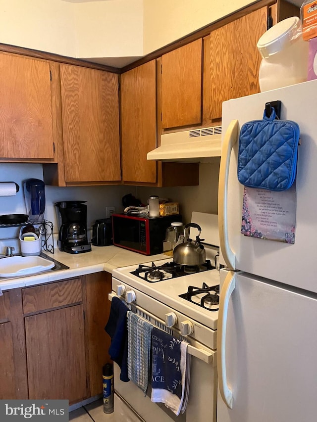 kitchen with sink and white appliances