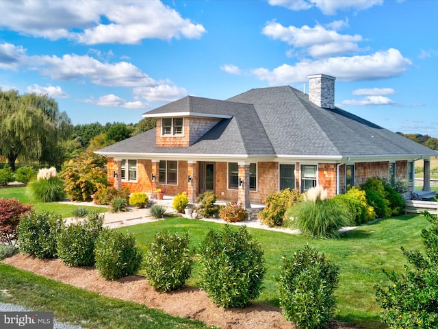 view of front of house with covered porch and a front yard