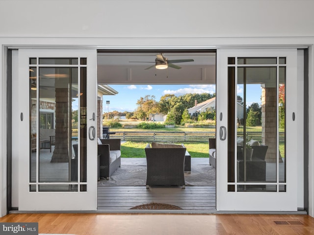 entryway with ceiling fan and wood-type flooring