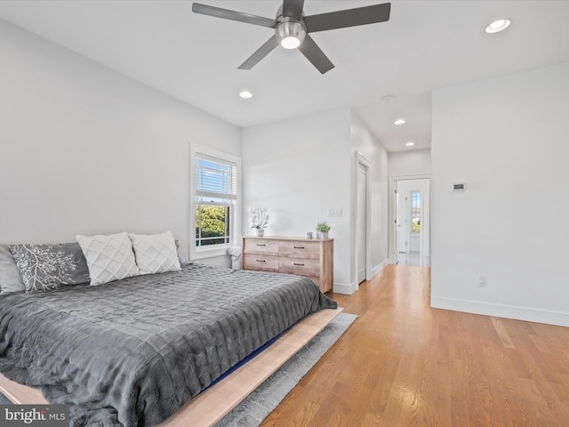 bedroom with light hardwood / wood-style flooring and ceiling fan