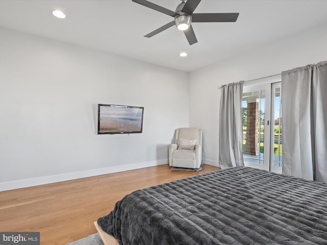 bedroom with access to outside, hardwood / wood-style flooring, and ceiling fan