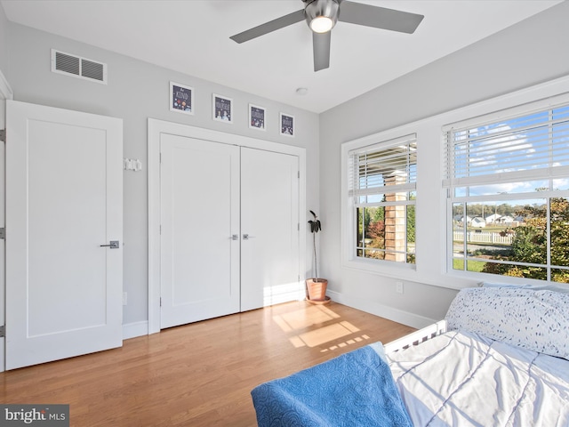 bedroom featuring a closet, light wood-type flooring, and ceiling fan