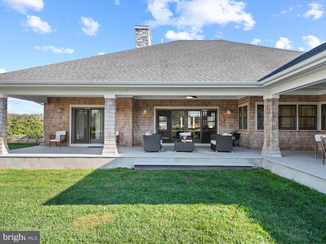 back of property featuring a patio area, a lawn, and outdoor lounge area