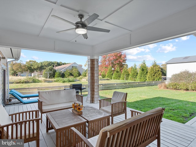 wooden deck featuring a yard and ceiling fan