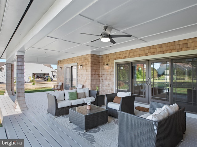 deck with an outdoor living space, french doors, and ceiling fan