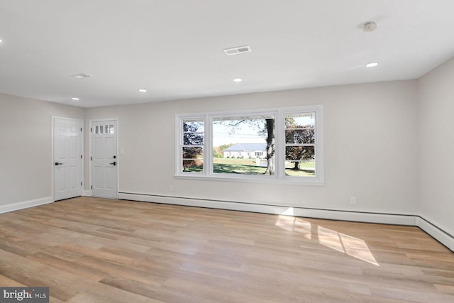 entryway with a baseboard radiator and light hardwood / wood-style flooring