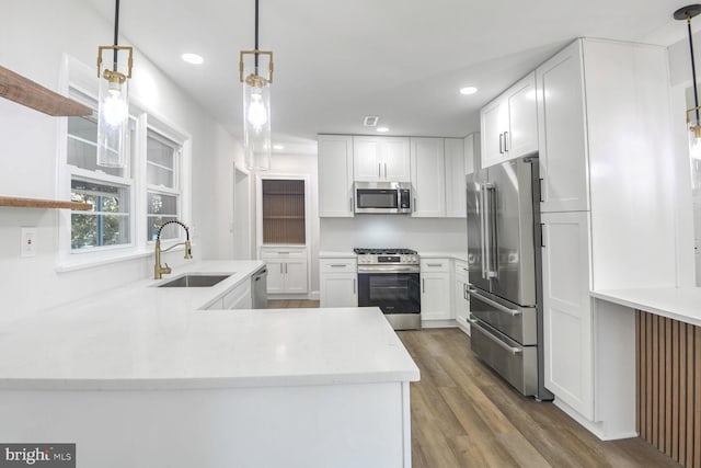 kitchen featuring white cabinets, stainless steel appliances, and sink