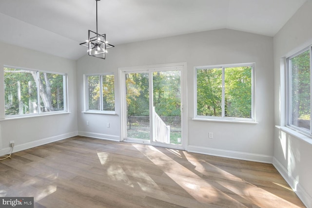 unfurnished sunroom with a chandelier and vaulted ceiling