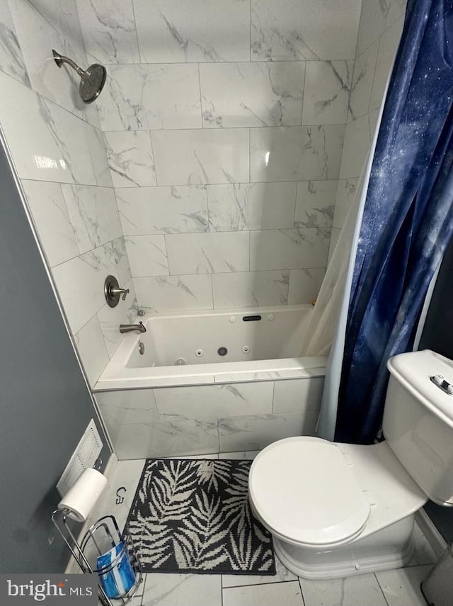 bathroom with shower / bath combo and toilet