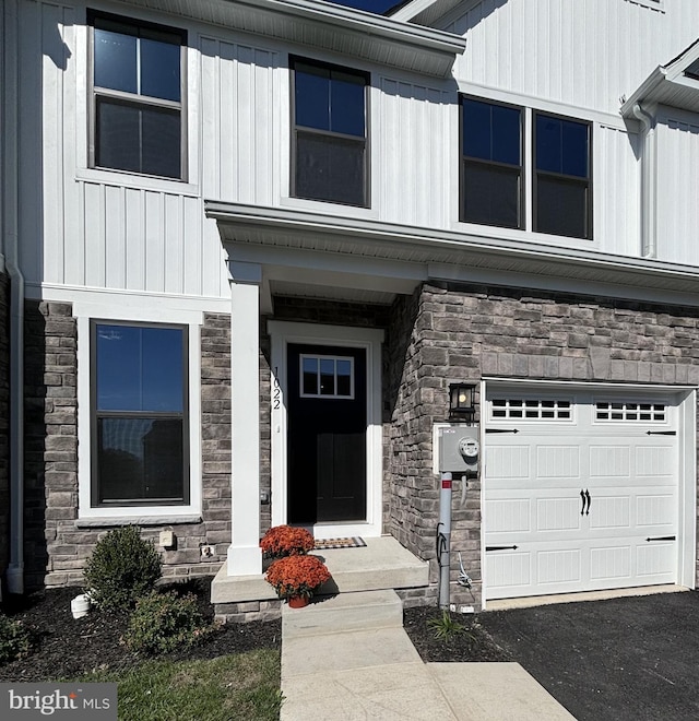 view of exterior entry featuring a garage