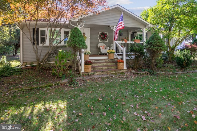 view of front of house with a porch and a front lawn