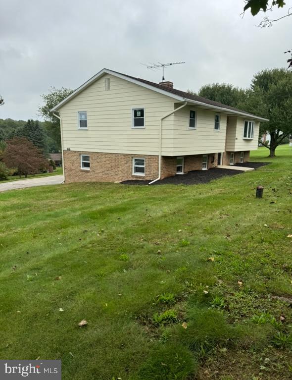 view of side of property with a lawn