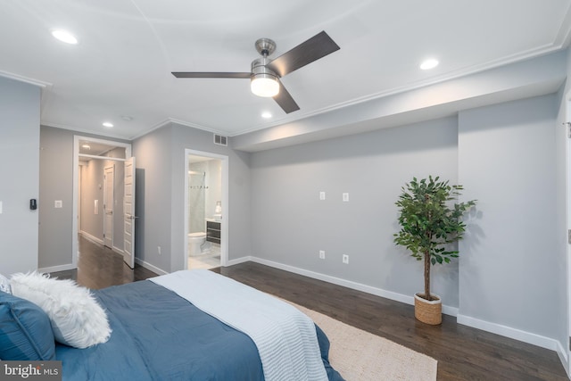 bedroom featuring ceiling fan, connected bathroom, dark hardwood / wood-style flooring, and crown molding