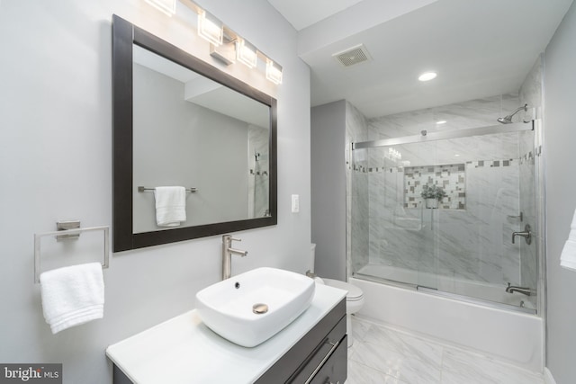 full bathroom with toilet, vanity, and enclosed tub / shower combo