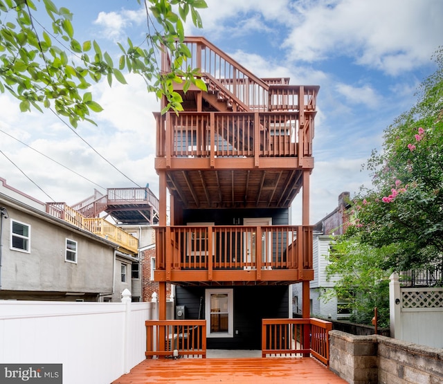 rear view of property featuring a wooden deck