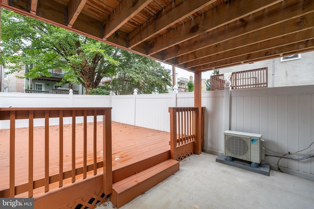 wooden deck with a patio and ac unit