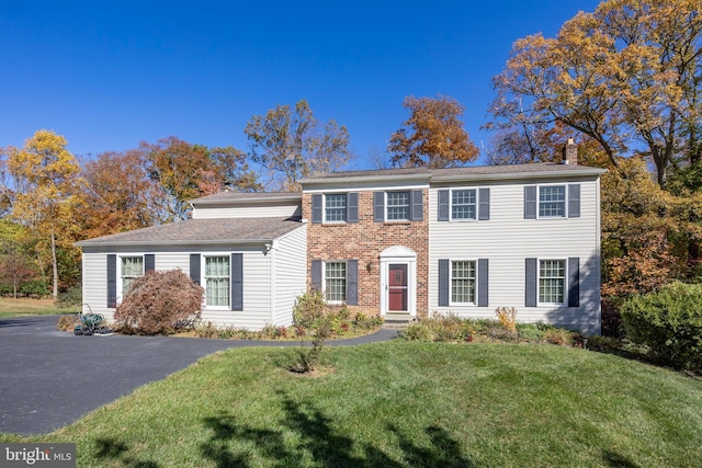 colonial home with a front yard