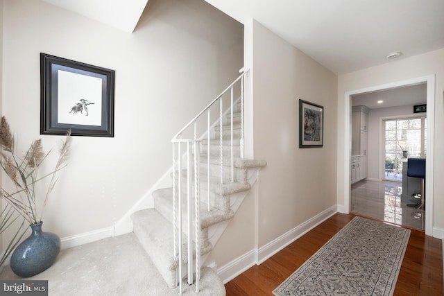 stairs featuring hardwood / wood-style flooring