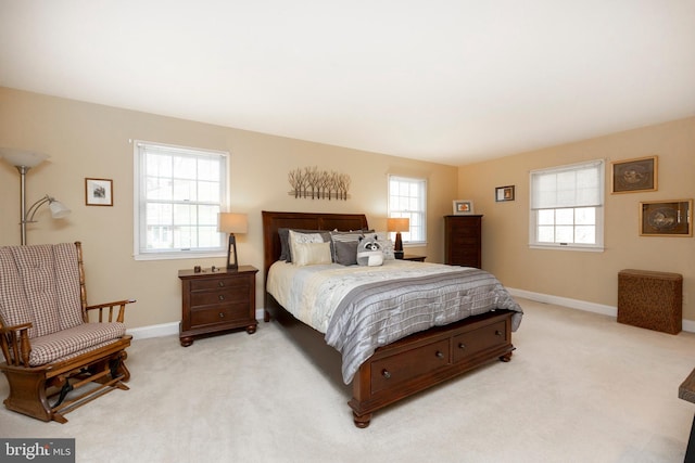 carpeted bedroom with multiple windows