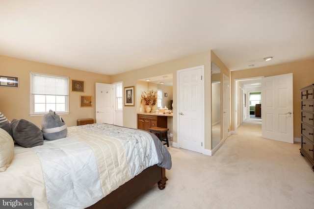 carpeted bedroom featuring ensuite bathroom