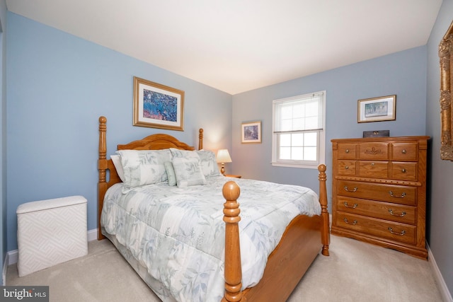 bedroom featuring light carpet