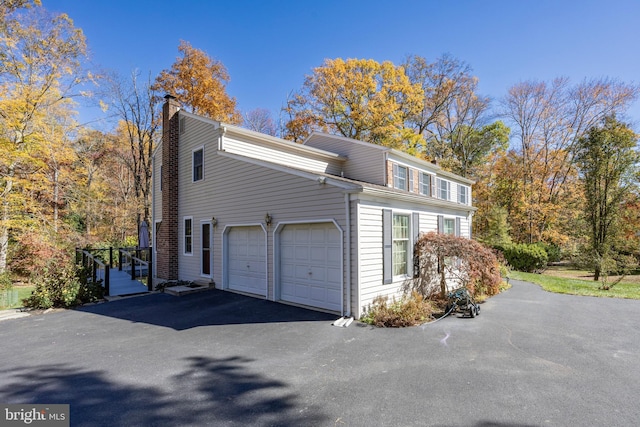 view of side of property with a garage