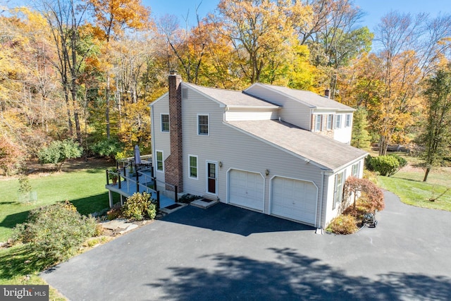 view of side of property with a yard and a garage