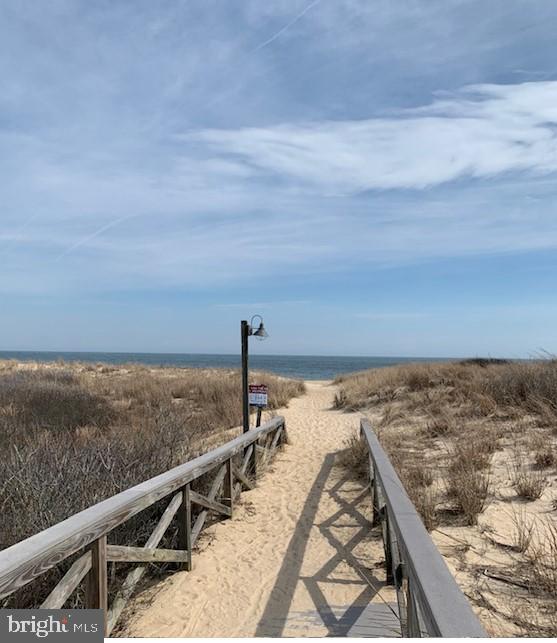 view of property's community with a view of the beach and a water view