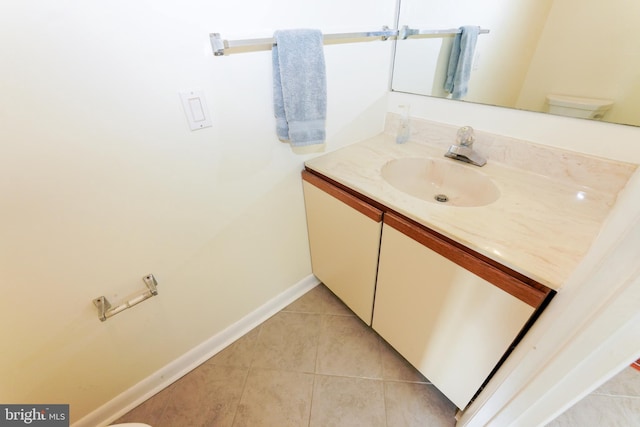 bathroom with tile patterned floors, vanity, and baseboards