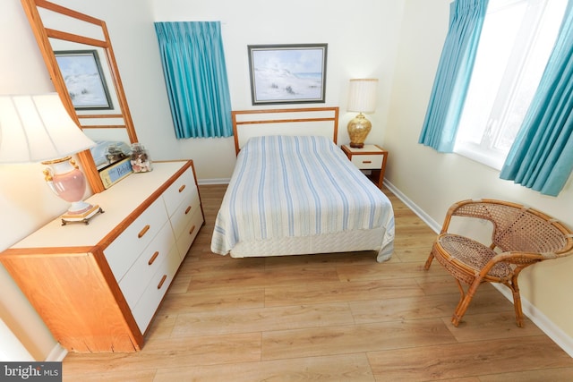 bedroom featuring light wood-type flooring and baseboards