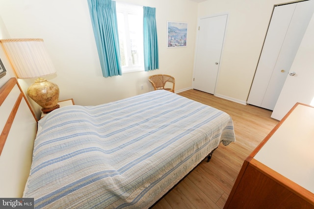 bedroom featuring baseboards and wood finished floors