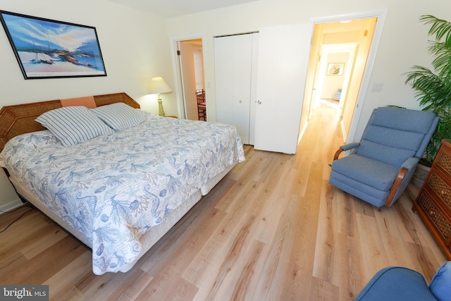 bedroom with a closet and light wood-style flooring