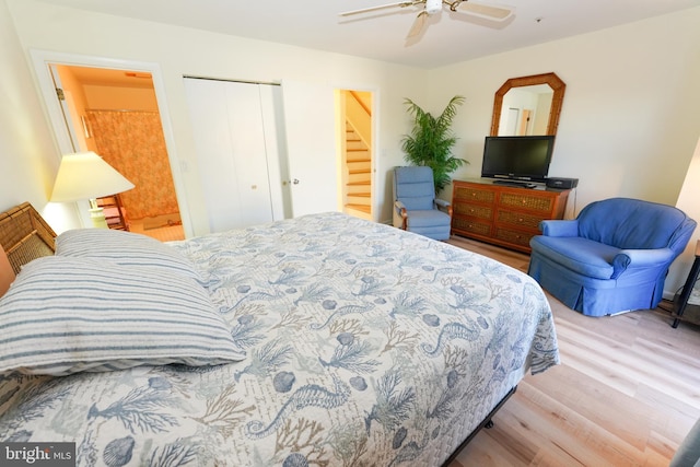 bedroom featuring wood finished floors, a closet, and a ceiling fan