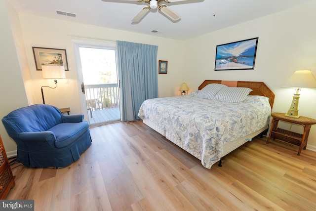 bedroom with light wood finished floors, visible vents, and access to outside