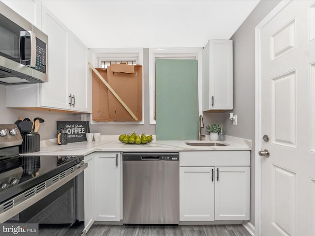 kitchen featuring white cabinets, light hardwood / wood-style floors, sink, and appliances with stainless steel finishes