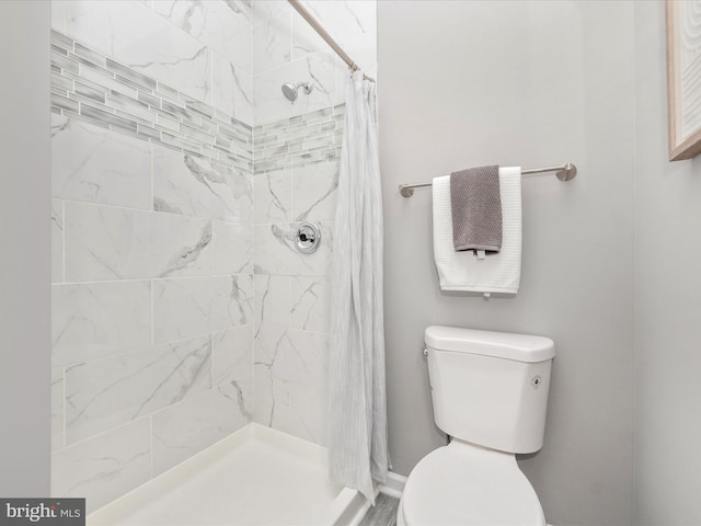 bathroom with a shower with curtain and toilet