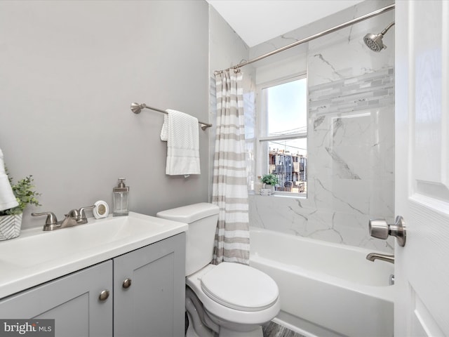 full bathroom featuring shower / bath combo, vanity, and toilet