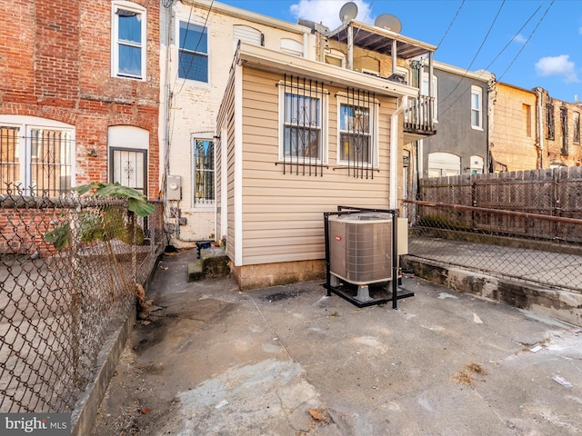 rear view of property with a patio and central AC