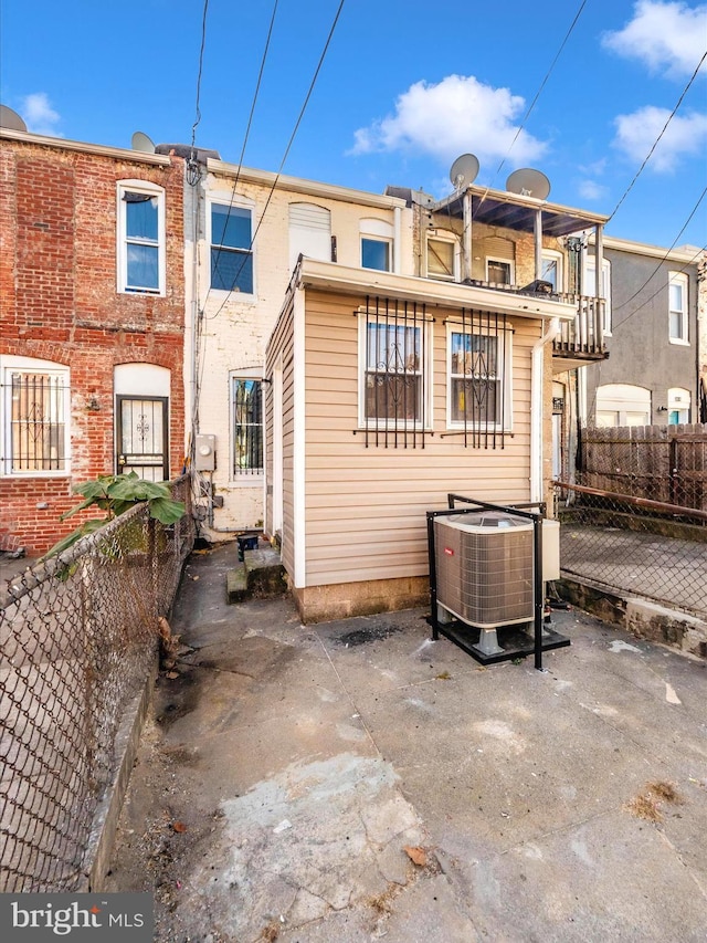 back of property featuring cooling unit and a patio