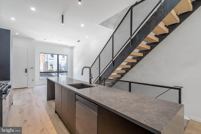 kitchen featuring a large island, light hardwood / wood-style flooring, dishwasher, and sink