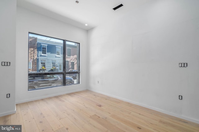 unfurnished room with light wood-type flooring