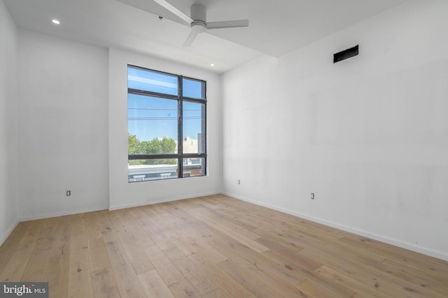 unfurnished room with ceiling fan and light hardwood / wood-style flooring