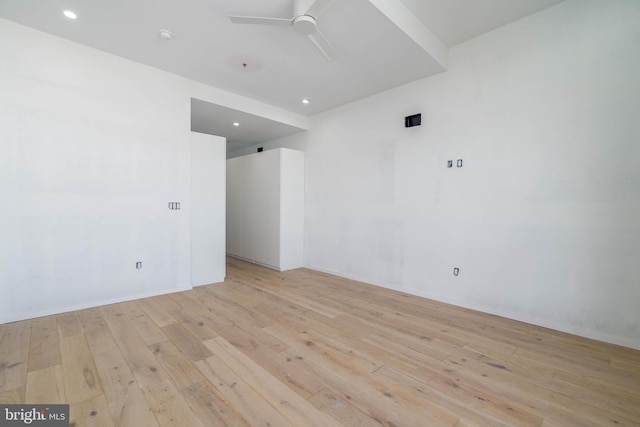 empty room featuring ceiling fan and light hardwood / wood-style flooring