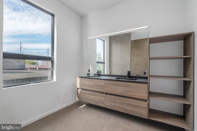 bathroom featuring tile patterned floors, vanity, and a healthy amount of sunlight