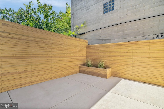 view of patio / terrace featuring fence