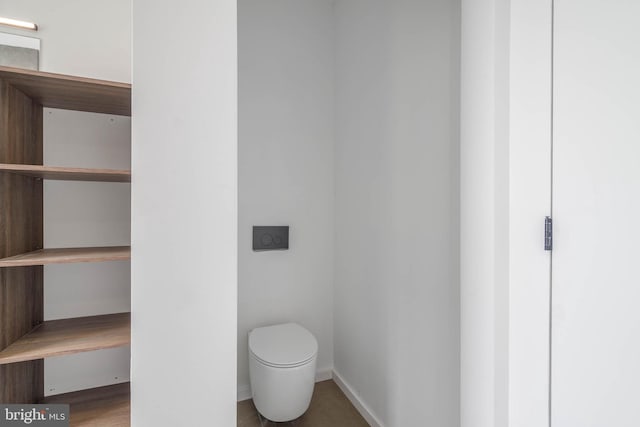 bathroom featuring hardwood / wood-style flooring and toilet