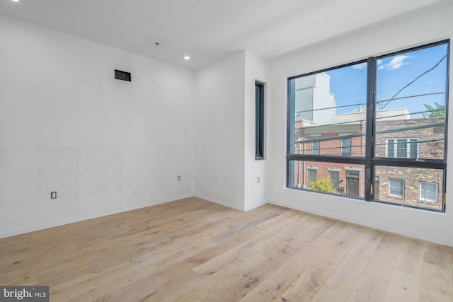 unfurnished room featuring light hardwood / wood-style flooring