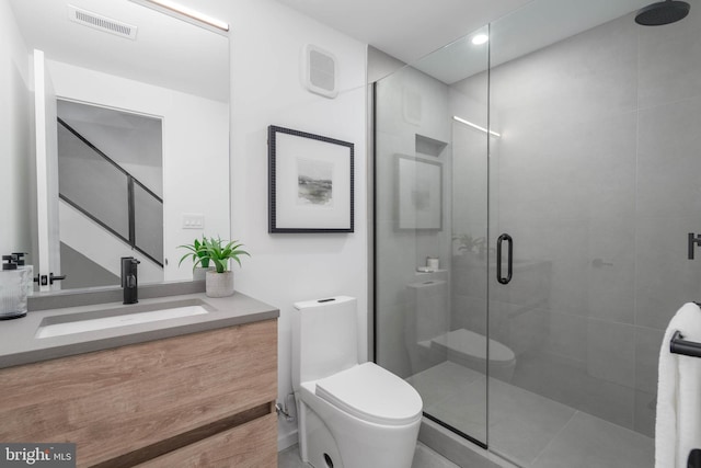 bathroom featuring vanity, toilet, and walk in shower