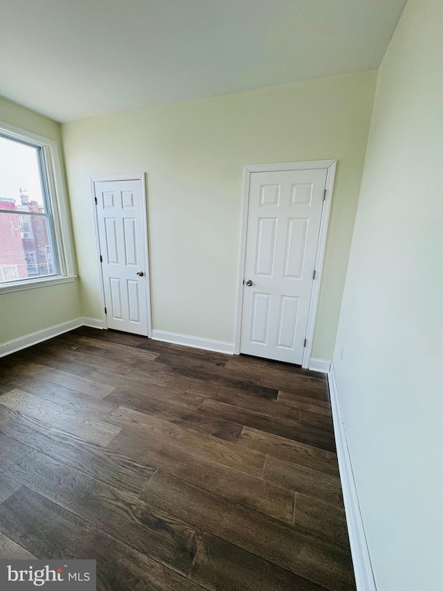 spare room featuring dark hardwood / wood-style flooring