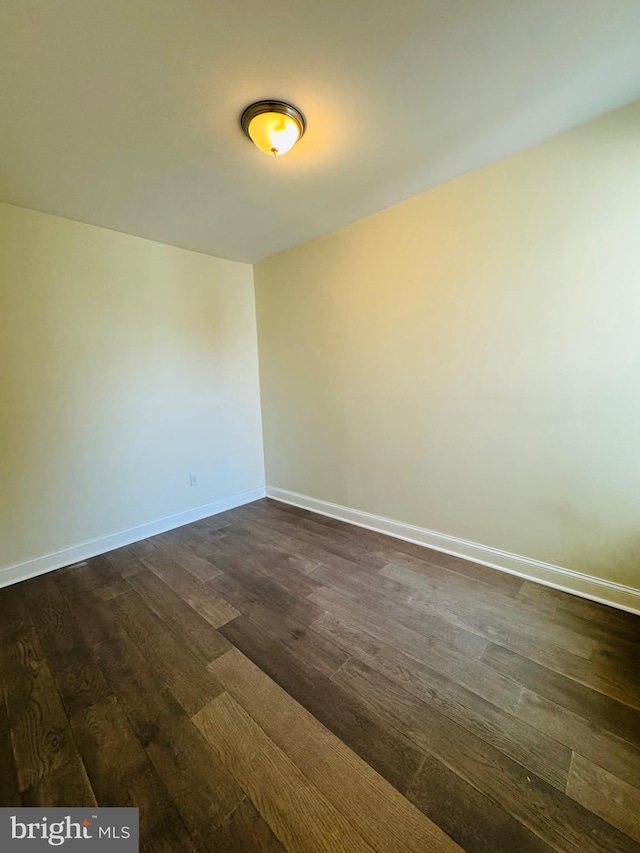 spare room featuring dark hardwood / wood-style floors